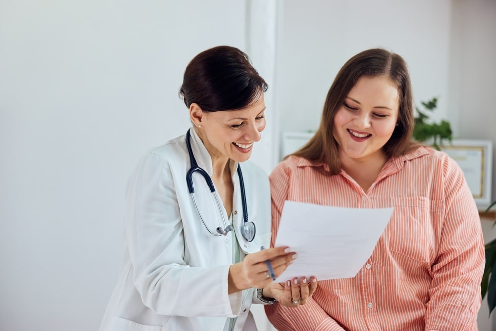 Happy, overweight woman having a consultation with her doctor to create a personalized weight loss plan.