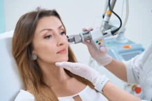 Middle-aged woman having a CO2 laser skin resurfacing treatment done to improve skin texture and clarity.