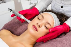 Beautiful woman looking very relaxed while receiving a microneedling treatment for improved skin.