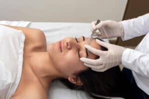 Close-up of a young woman having a dermaplaning treatment done for smoother, more even skin.